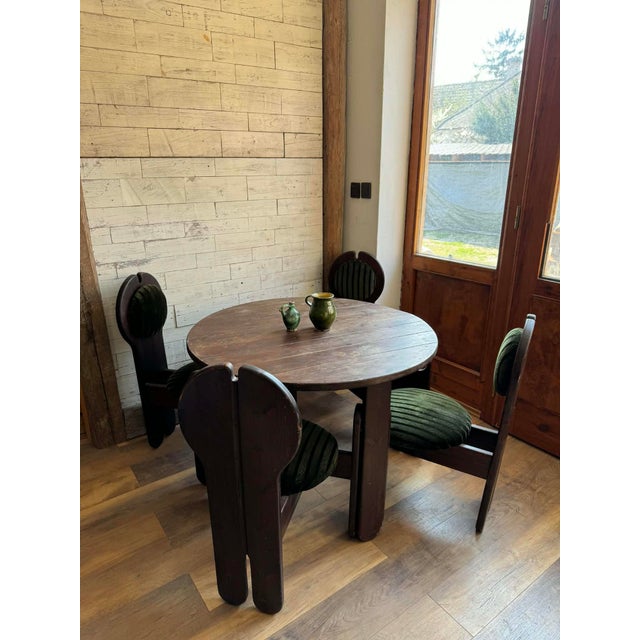 This rare vintage dining set designed by Szedleczky Mária in the 1960s includes a dining table and four matching chairs....