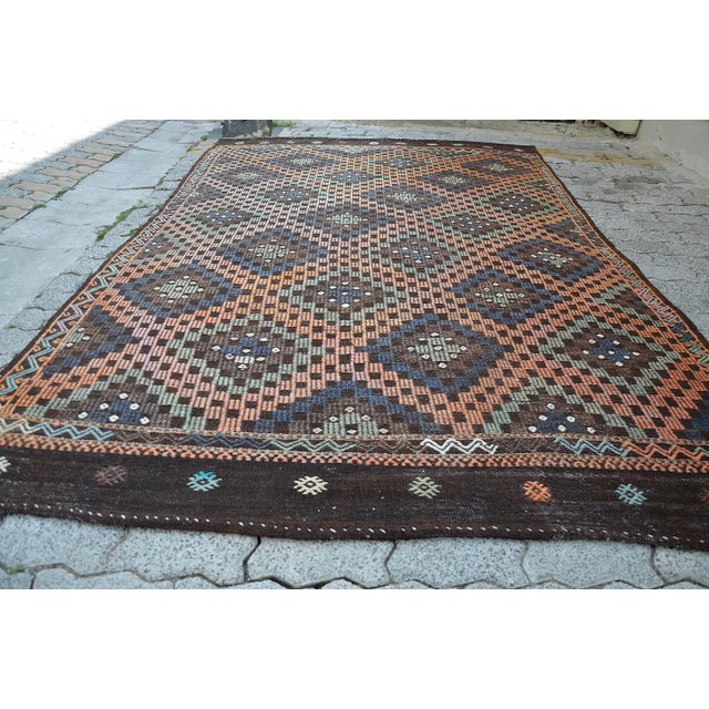 This is a vintage Turkish Anatolian kilim rug from the 1960s. The piece was hand-woven.