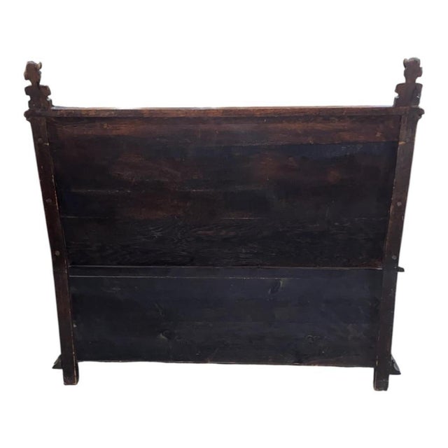 Richly decorated throughout, the high back is centred by two deeply carved panels depicting charming genre scenes of...