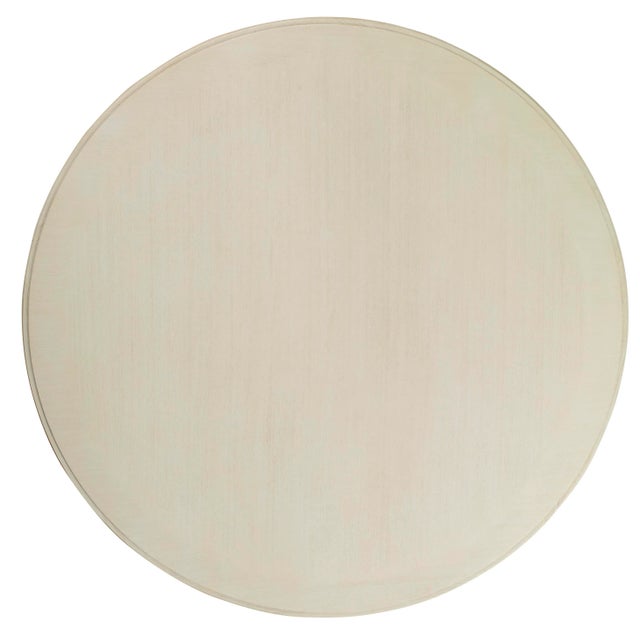 The Bardot Dining Table features a 60 oak round top with a veneered edge pattern and a multi-stepped beveled edge detail....