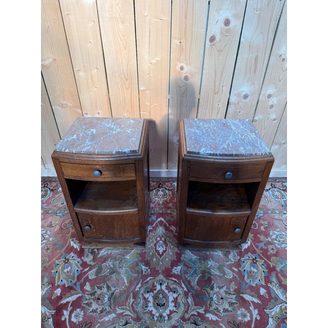 Pair of Art Deco bedside tables in solid oak, dating from the 1930s. Each piece features a curved front with a top drawer...