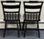 Beautiful pair of traditional Hitchcock chairs featuring a rich black finish accented with intricate gold floral...