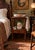 This is a two-tier wooden wash stand featuring a rectangular top, turned legs with ring and spool details, and a single...