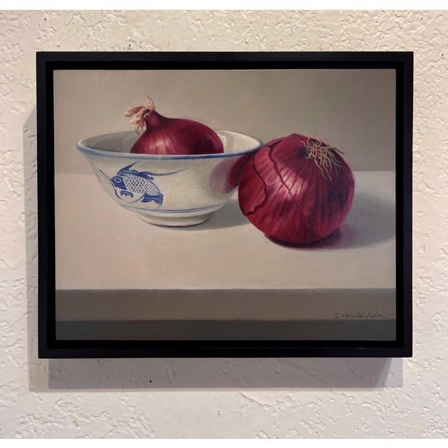 This oil on panel painting features two red onions, one resting beside a delicate bowl adorned with a blue fish motif. The...