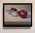 This oil on panel painting features two red onions, one resting beside a delicate bowl adorned with a blue fish motif. The...