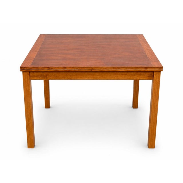 This table is a classic Danish/Scandinavian Modern draw-leaf dining table. The two extension leaves pull out from...