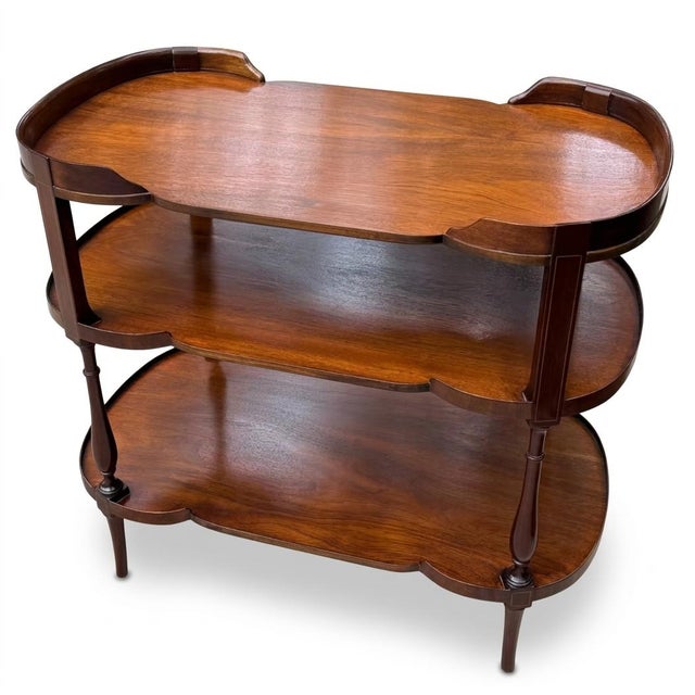 Mahogany server or etagere which also makes a wonderful bar. Elegant flared legs and curved lines. Very useful piece.