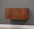 A mid century modern walnut cabinet credenza with brass knobs which hangs on a wall with a French cleat. Professionally...