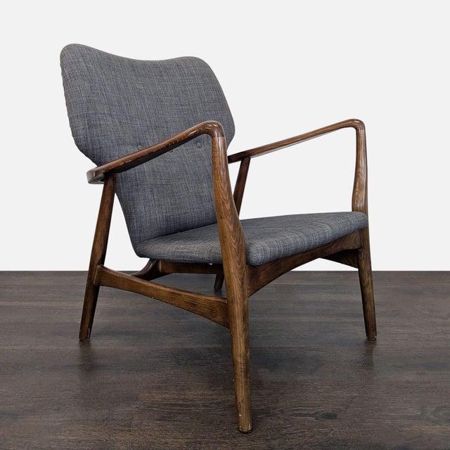 Relax in style with this lounge chair featuring a classic mid-century modern design. The sturdy wooden frame offers...