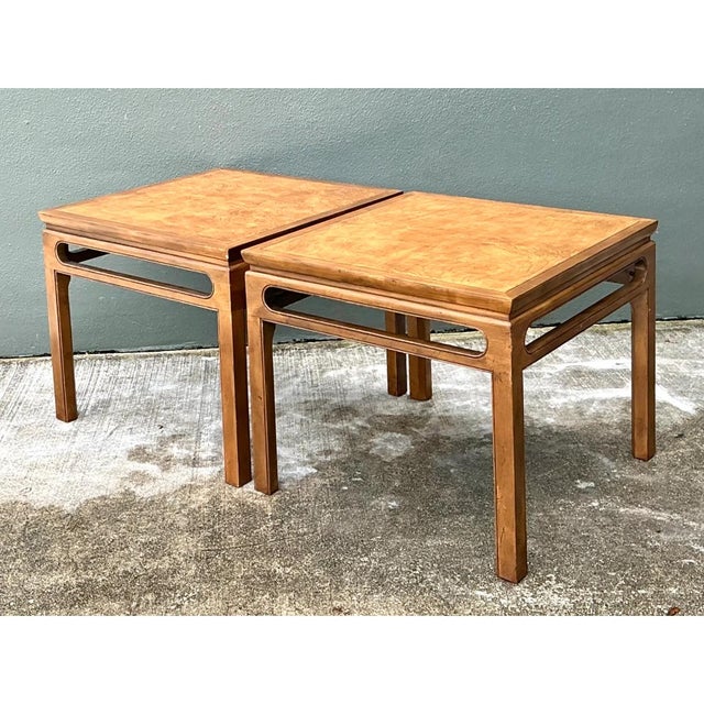 This pair of vintage Baker side tables pairs Asian-inspired architecture with a warm, honey-toned finish. Each square top...