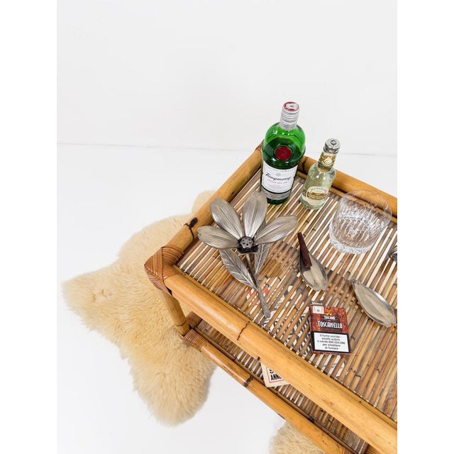 This elegant Italian bar cart, dating to the Mid-Century Modern period, is a superb example of the refined craftsmanship...