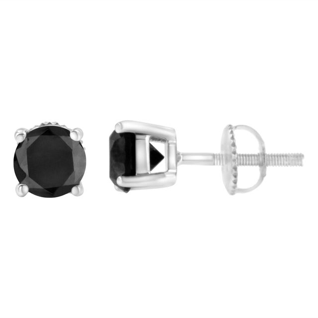 Elegant and timeless, these gorgeous 14K white gold solitaire stud earrings feature bold and beautiful heat treated, color...