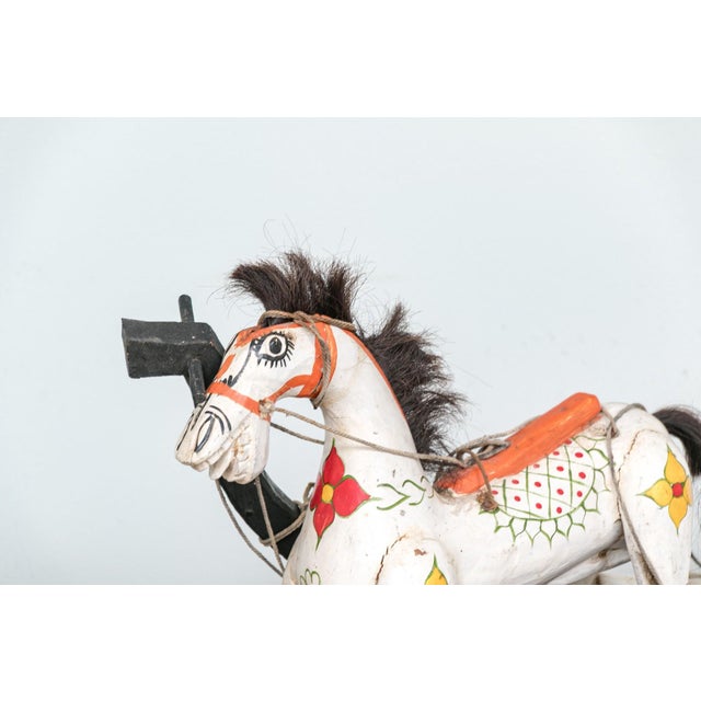 A vintage marionette puppet of a beautifully hand-carved horse adorned with intricate hand-painted details and horse hair...
