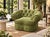 This is a large, heavily tufted armchair upholstered in an olive green textured chenille fabric. It features deep diamond...