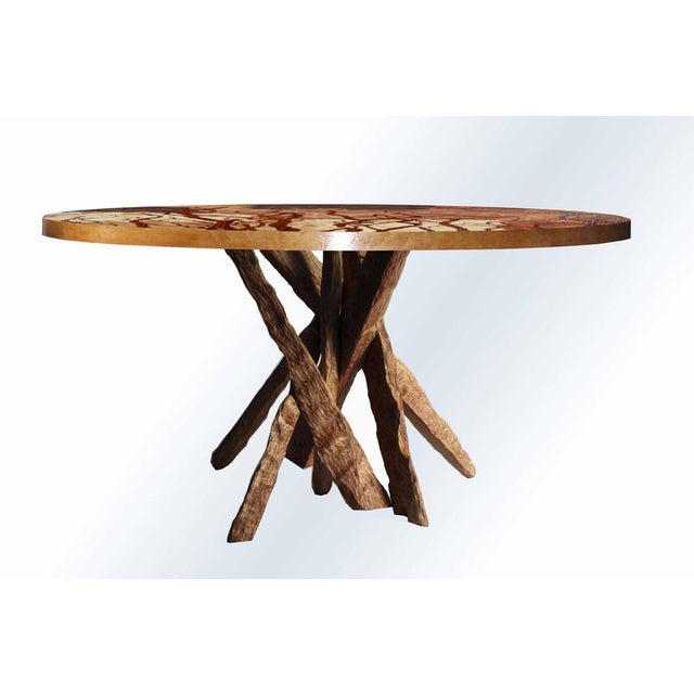 "Tarsia TT1" table. A circular table inlaid with various woods and a hand-carved cherry base. The table is handcrafted...