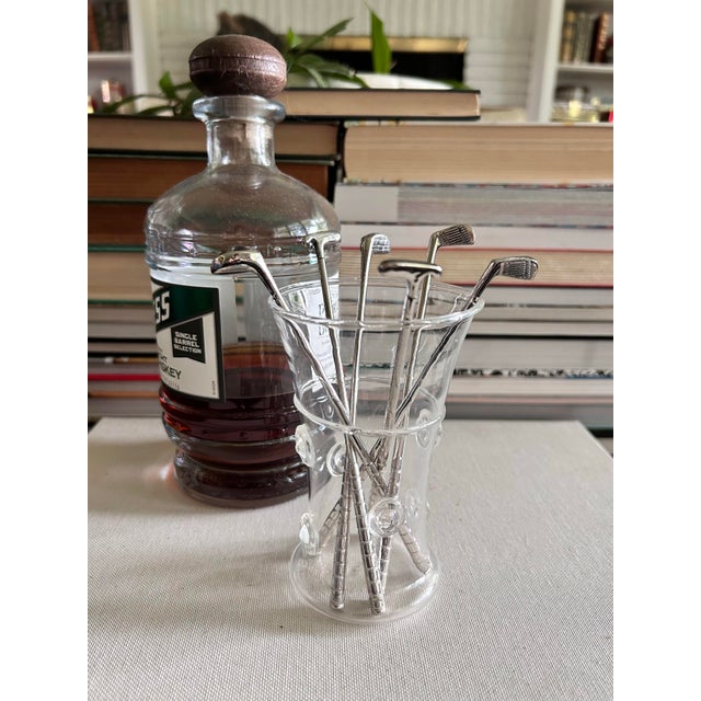 A complete set of six vintage silverplate cocktail stirrers modeled after classic golf clubs. The assortment includes two...