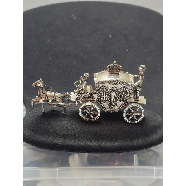 The product is a miniature horse carriage made of .800 silver, crafted in 1949 by H. Hooykaas in Schoonhoven, Netherlands....