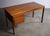A brilliant teak desk with book-matched grain sliding storage top and three drawers, by Peter Lovig Nielson, Denmark...