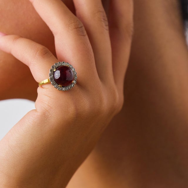 This beautiful Victorian garnet and diamond cluster ring is a romantic antique design from the 1880’s, centered by a...
