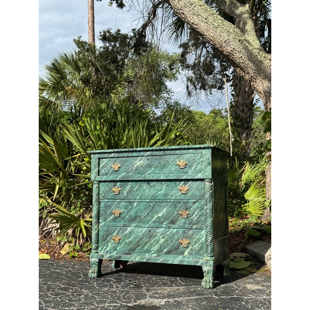 A truly unique antique chest of drawers featuring an incredible faux marble-painted finish in rich shades of emerald,...