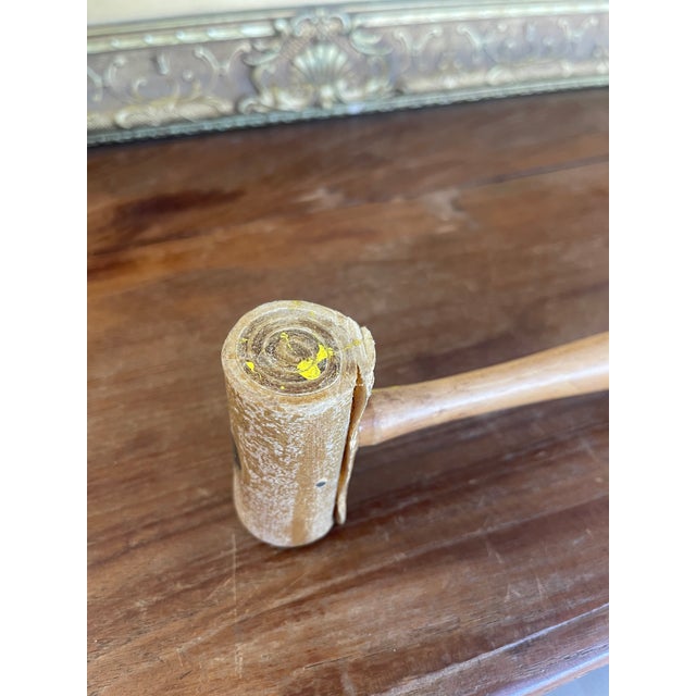 This vintage rawhide mallet features a cylindrical rawhide head secured with screws to a smooth, turned wooden handle. The...