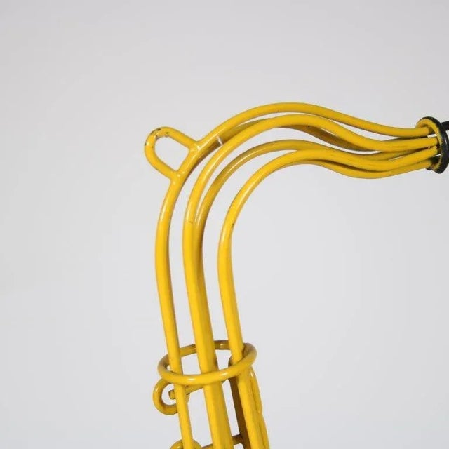 A unique object: a wire metal rack in saxophone shaped! Produced in the Netherlands around 1960. The yellow lacquered wire...