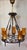 Vintage Rustic Chandelier in Wrought Iron, Brass, and Amber Glass Shades, 1970s, in Very Good conditions. Designed 1970 to...