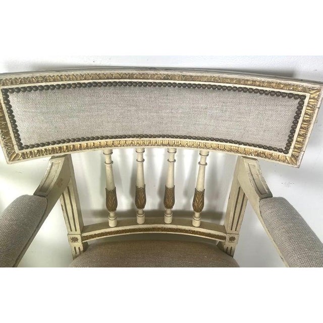Italian Neoclassical style armchairs with a painted & parcel gilt finish. This style is characterized by its neoclassical...