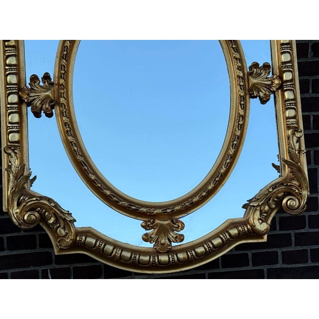 Add refined European elegance to your interior with this striking Louis XVI-style wall mirror, crafted circa 1970. With...