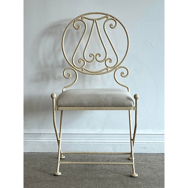 Add a touch of romantic, architectural interest to your home with this exceptional vintage wrought iron accent chair....