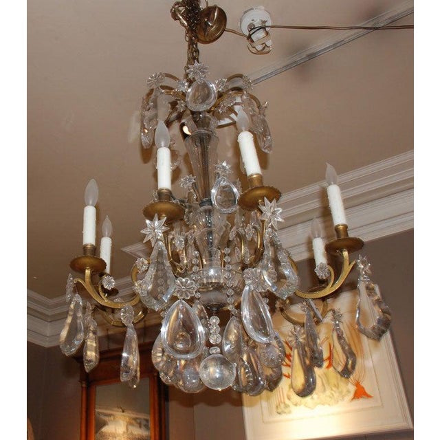 Exceptional period French eight-light gilt bronze chandelier having very large thick crystals. These large, thick crystals...