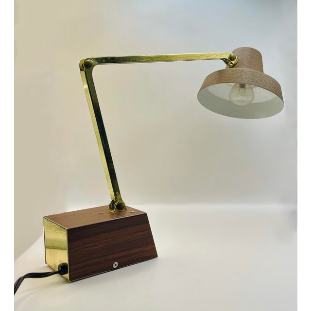 A classic faux wood and brass desk lamp made by the Tensor Company in Brooklyn, New York. Both high and low modes function...
