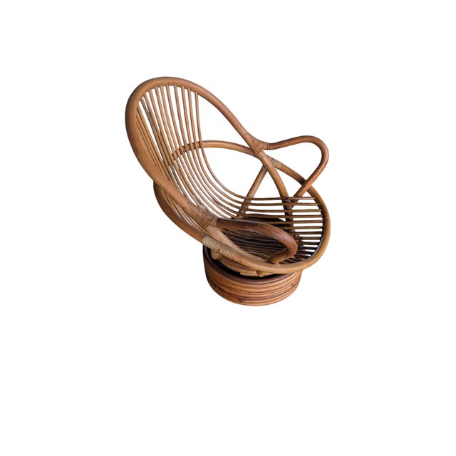 An exceptional Mid-Century Modern vintage rattan swivel lounge chair that effortlessly marries organic warmth with...