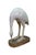 Hand-carved wooden sculpture depicts a stylized wading bird, such as a crane, stork, or egret, captured in a dynamic...