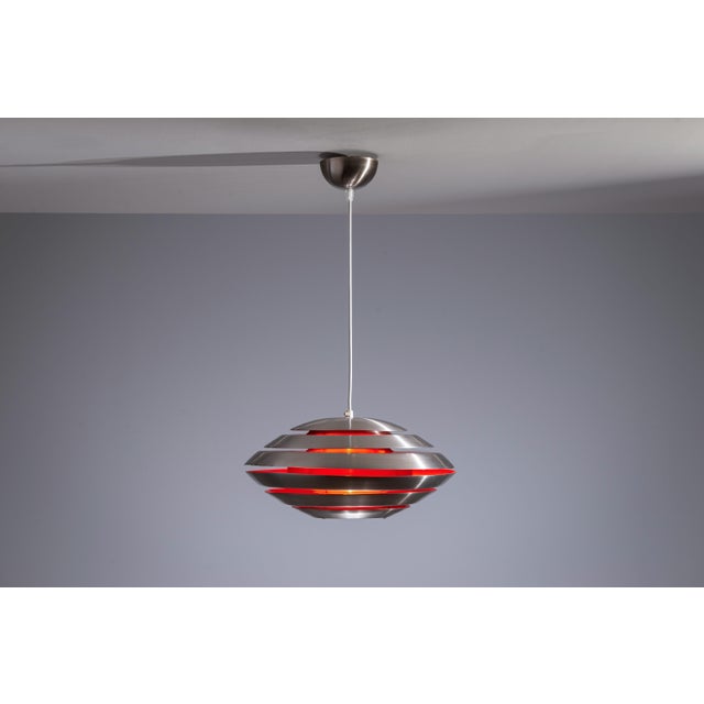 This striking multi-layered pendant by Swedish designer Carl Thore is a timeless example of Scandinavian modern lighting....