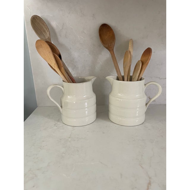 Love these English creamware dairy pitchers. They are banded around the body and a beautifully patinated cream color....