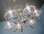 Elegant pyra chandelier constructed of brass with cream colored painted florets and socket covers accented with crystal...