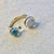 Created in 18 karat yellow gold Moon quartz 2 cts approx Blue topaz 2 cts approx Diamond 0.04 ct approx Open ring Limited...