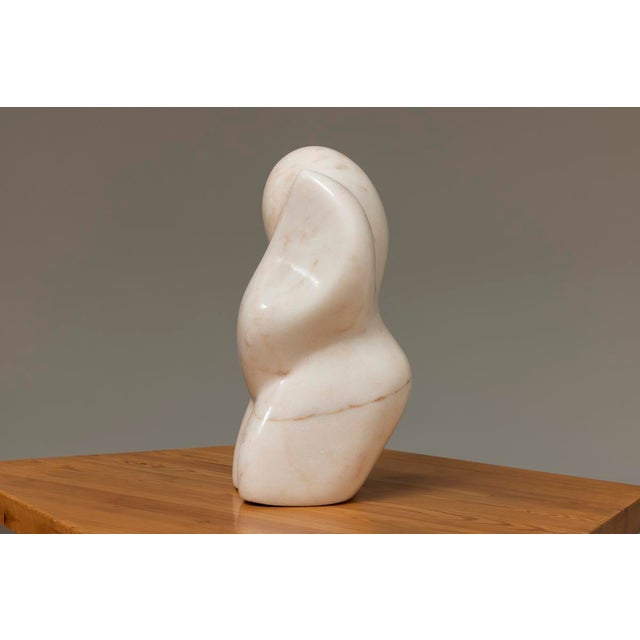 Sculpture, Maternity II, by Maurice Mader made out of pink marble in 1991. This piece has an attribution mark, I am sure...