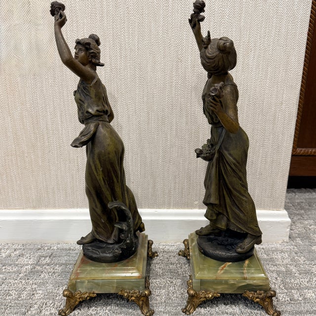 Pair of Signed Emile Carlier Bronze Sculptures A pair of 19th century bronze sculptures on marble bases. Marchand de...