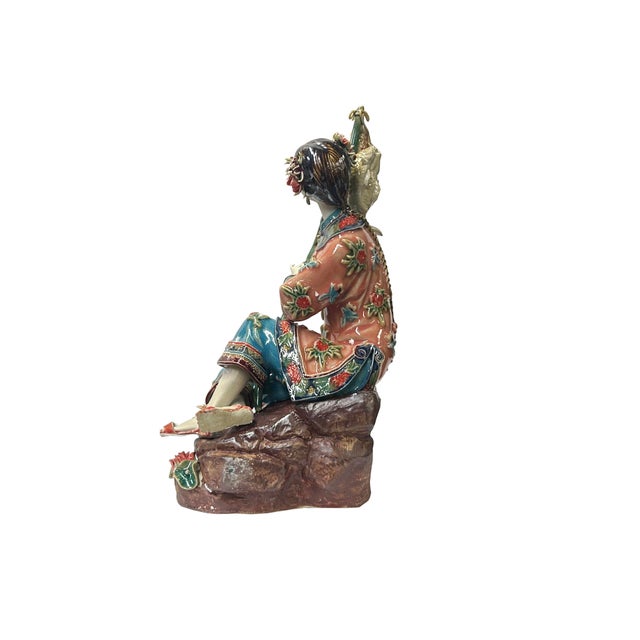 This Chinese Qing style dressing lady figurine is a beautiful and delicate piece of art. It is made of ceramic pottery and...