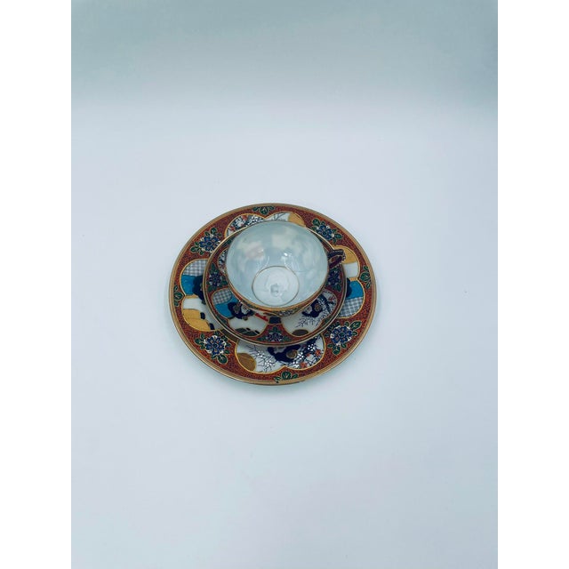 A collectible trio cup, produced in Japan between the 1930s and 1950s in the opulent Satsuma, Kutania style, made of high-...