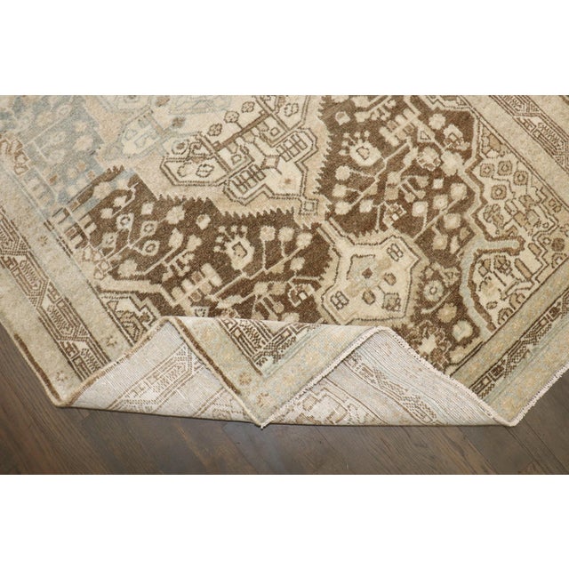 a 2nd quarter of the 20th century Persian Malayer Runner with multiple medallions and neutral abrashed colors