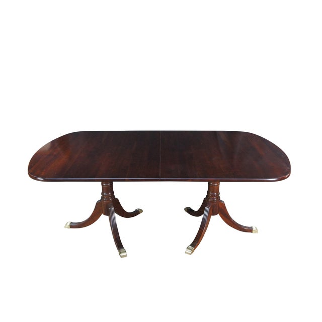 A stately solid cherry dining table by Williams Sonoma Home. Features a English Regency styling with a cherry top over...