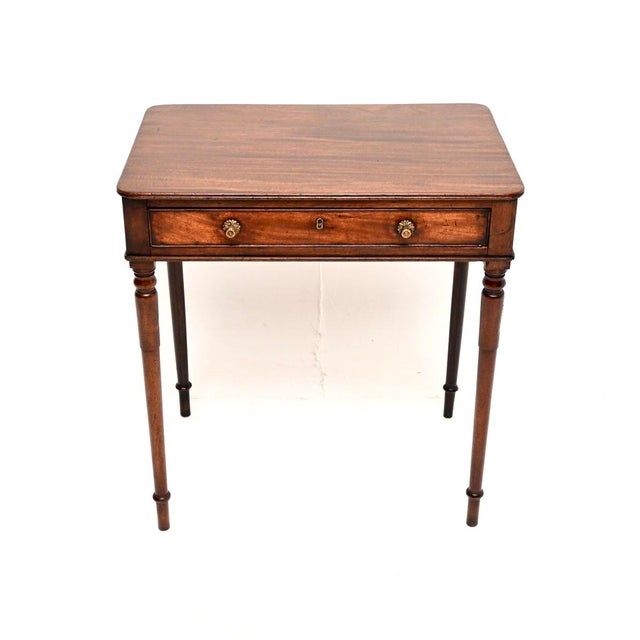 A gorgeous antique Georgian period side table, made in England and dating from around the 1810-1820 period. It is of...