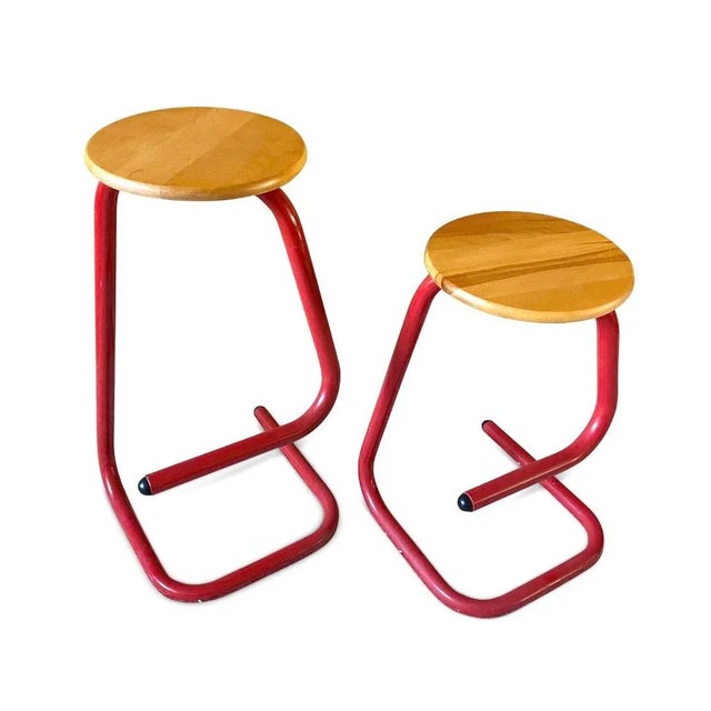 Pair of Les Industries Amisco 'paperclip' stools. These fantastic non-identical red bar stools have stunning tubular steel...