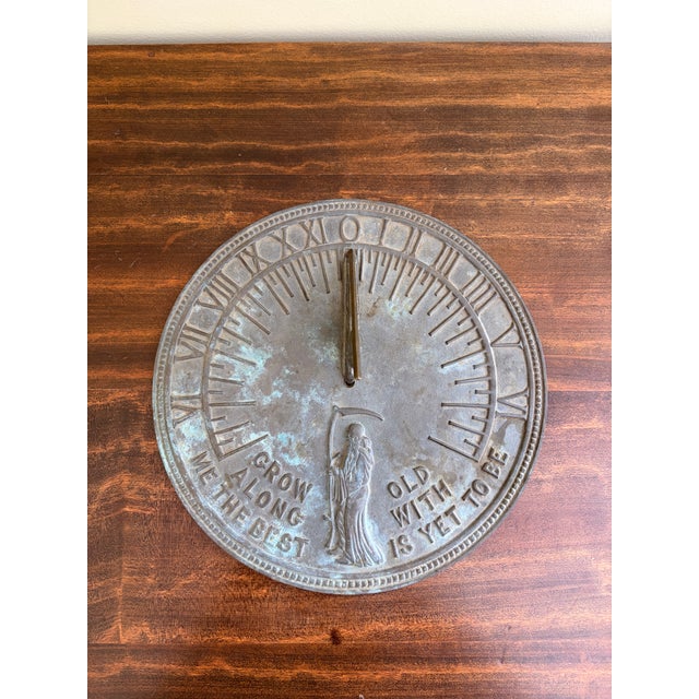 A stunning vintage iron garden sundial reading "Grow old along with me. The best is yet to be." USA, Late 20th Century...
