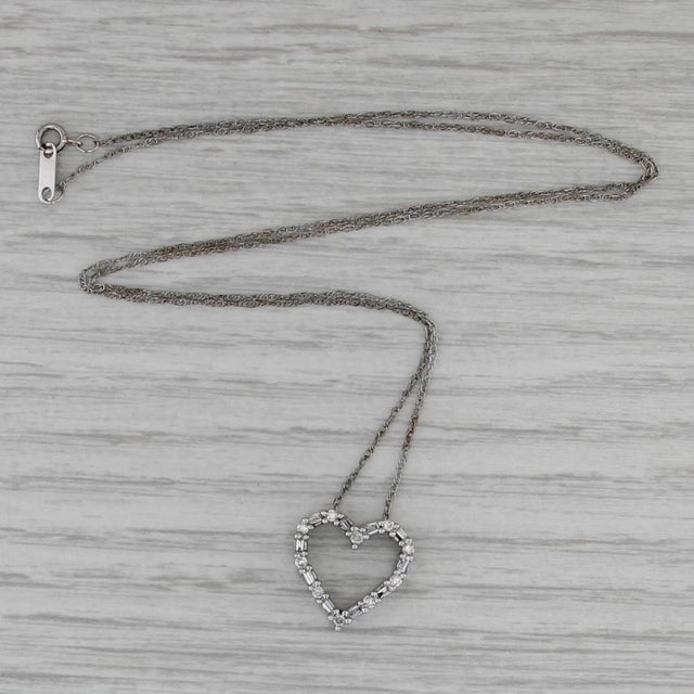 Gemstone Information: - Natural Diamonds - Total Carats - 0.23ctw Cut - Round Brilliant 0.12ctw, Baguette 0.11ctw Color -...