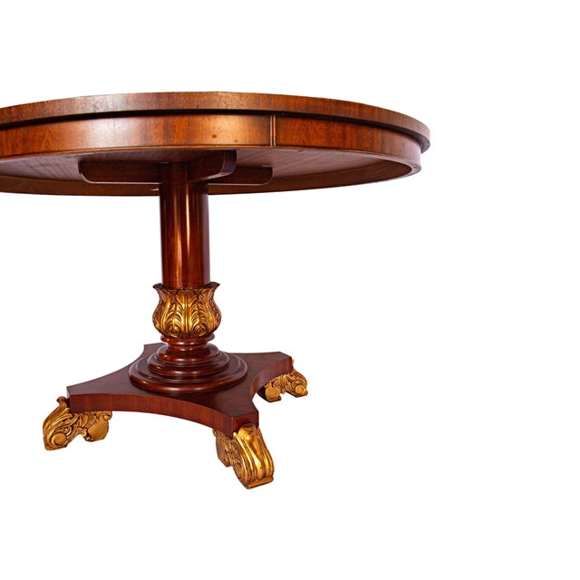 Elegant vintage Federal-style table crafted in rich mahogany with refined gilded accents. This classic form features...