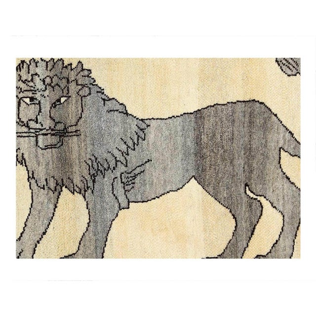 Highlighting the powerful imagery of a prowling Lion, the carpet's central motif features a cream lion atop a rich red...